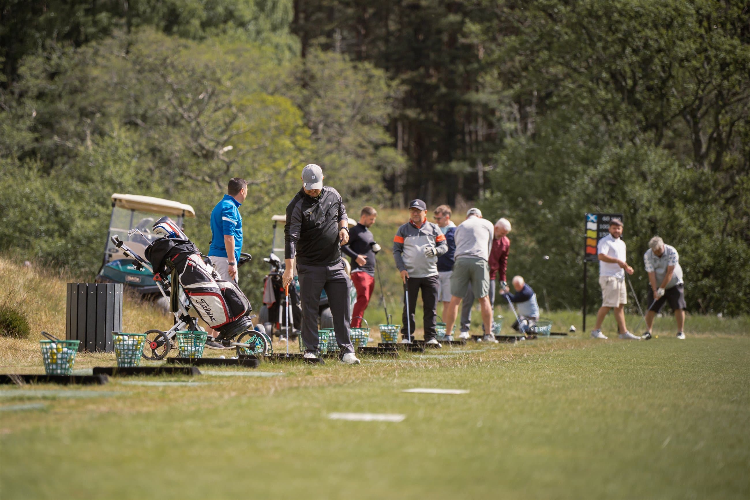 Golfers preparing on a Highland driving range