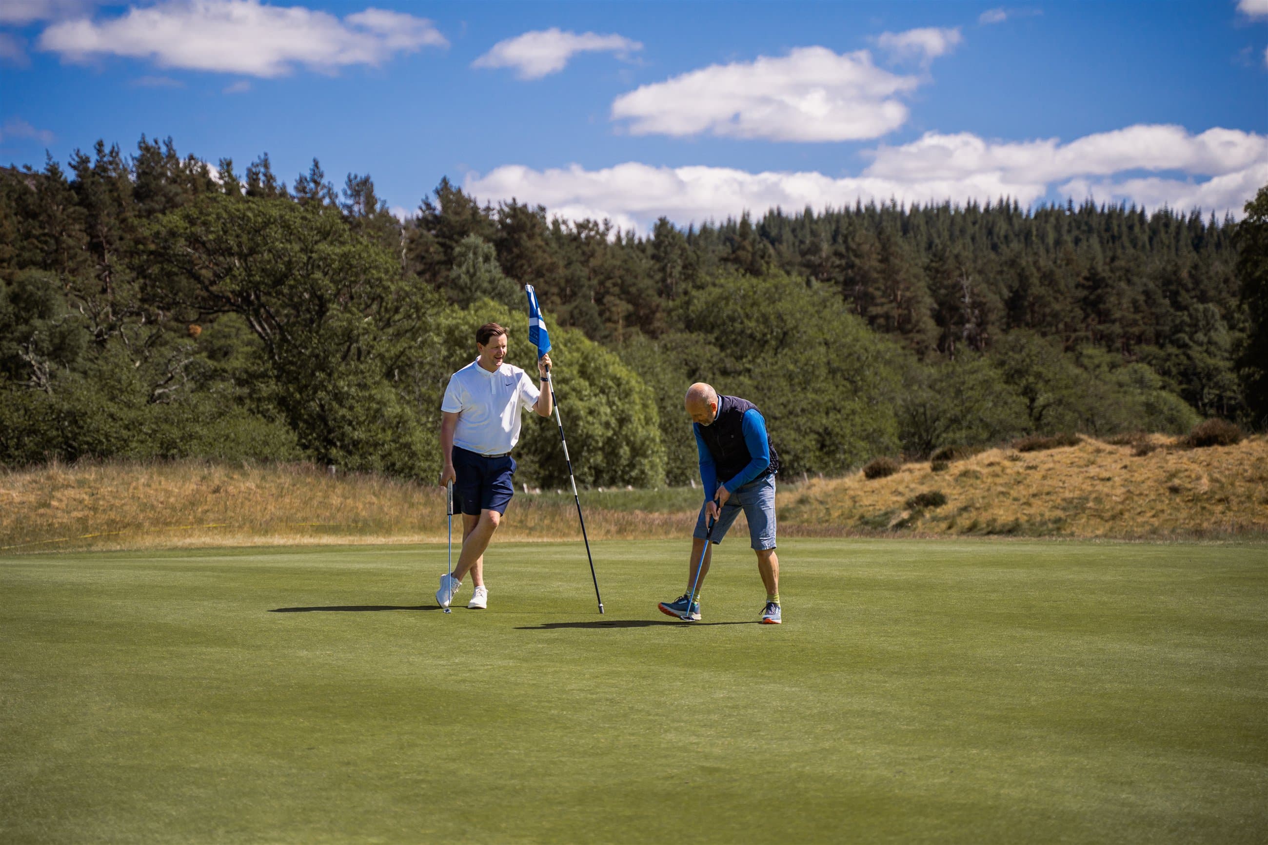 Two golfers on a green during a Highland client project
