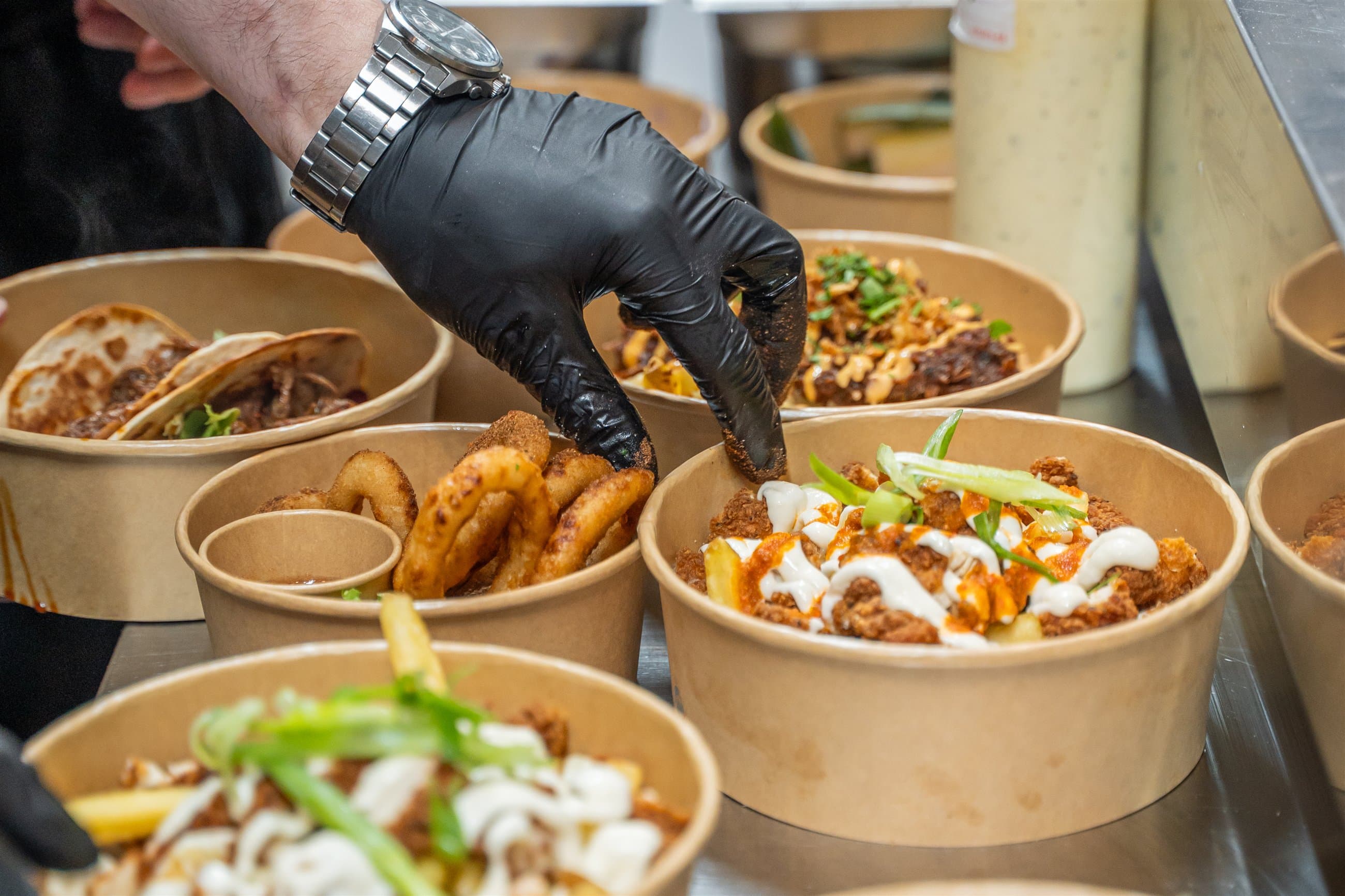 Chef finishing freshly prepared dishes during service